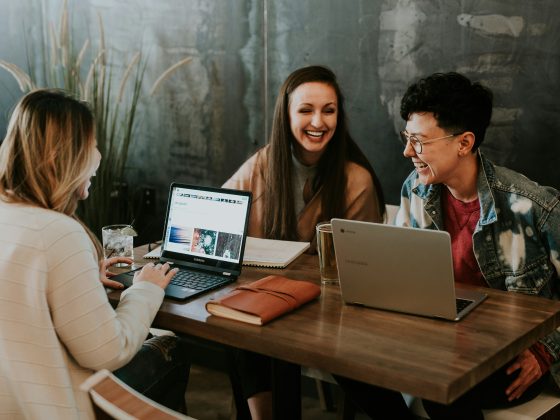 Team collaborating at a table with computers